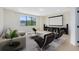 Relax in this expansive living room with a large window for natural light and a projection screen for entertainment at 5116 Sorrento W Blvd, St Cloud, FL 34771