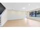A bright living room with light wood flooring, a large window, and neutral walls at 5116 Sorrento W Blvd, St Cloud, FL 34771