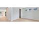 Bright, empty living room with hardwood floors and three windows providing natural light at 5116 Sorrento W Blvd, St Cloud, FL 34771
