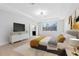 Modern primary bedroom boasts large window, smooth floors, ensuite bath, and contemporary decor at 5116 Sorrento W Blvd, St Cloud, FL 34771