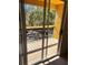 Balcony with view to the street showing metal guardrail, mature trees, and space for outdoor furniture at 5291 Images Cir # 301, Kissimmee, FL 34746