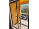 Balcony view showcasing a metal guardrail, an adjacent wall, and tree view at 5291 Images Cir # 301, Kissimmee, FL 34746