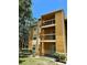 A three-story condo building with balconies, mature trees and nice landscaping at 5291 Images Cir # 301, Kissimmee, FL 34746