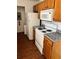 Efficient kitchen with wooden cabinets and essential white appliances at 5291 Images Cir # 301, Kissimmee, FL 34746