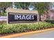 Sign for the community with manicured landscaping around it at 5291 Images Cir # 301, Kissimmee, FL 34746