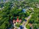 House aerial with pin drop showing location near tennis courts, road, and lake at 602 Nighthawk Cir, Winter Springs, FL 32708