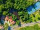 Aerial view of house showing proximity to the lake, tennis courts, and green space at 602 Nighthawk Cir, Winter Springs, FL 32708