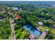 House aerial with pin drop showing location near a larger lake and tennis courts at 602 Nighthawk Cir, Winter Springs, FL 32708