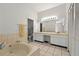 Bright primary bathroom with double vanity, tub, and walk-in closet at 602 Nighthawk Cir, Winter Springs, FL 32708