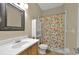 A full bath features a large, ornate mirror, commode, linen closet and a playful shower curtain at 602 Nighthawk Cir, Winter Springs, FL 32708