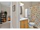 Cozy bathroom with a vanity, commode, and shower featuring a colorful shower curtain at 602 Nighthawk Cir, Winter Springs, FL 32708