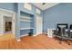 A light blue bedroom features built-in shelves, a closet, and wood floors at 602 Nighthawk Cir, Winter Springs, FL 32708