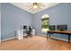 A spacious bedroom features light blue walls, wood floors, and large windows for natural light at 602 Nighthawk Cir, Winter Springs, FL 32708