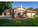 Home's exterior showcasing the screened patio area and well-maintained lawn at 602 Nighthawk Cir, Winter Springs, FL 32708