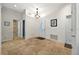 Bright foyer with tile flooring, a white front door, and views of the hallway and bathroom at 602 Nighthawk Cir, Winter Springs, FL 32708