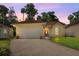 Charming single-story home with a red tile roof, well-manicured lawn, and a two-car garage at 602 Nighthawk Cir, Winter Springs, FL 32708