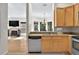 A bright kitchen features stainless appliances and opens to the living and dining areas at 602 Nighthawk Cir, Winter Springs, FL 32708
