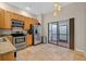 An eat-in kitchen features stainless appliances, wood cabinets and access to a tiled lanai at 602 Nighthawk Cir, Winter Springs, FL 32708