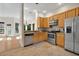An updated kitchen features stainless appliances and wood cabinets and opens into a dining nook at 602 Nighthawk Cir, Winter Springs, FL 32708