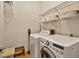 A laundry room with washer, dryer, and wire racks at 602 Nighthawk Cir, Winter Springs, FL 32708