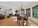 A dining area with hardwood floors flows into a living room with leather sofas and a fireplace at 602 Nighthawk Cir, Winter Springs, FL 32708