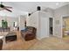 Inviting living room with wood flooring, a ceiling fan, and views of the dining area and kitchen at 602 Nighthawk Cir, Winter Springs, FL 32708