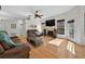Bright living room featuring a fireplace, hardwood floors, and lots of natural light at 602 Nighthawk Cir, Winter Springs, FL 32708