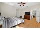 Spacious bedroom with ensuite bathroom, hardwood floors, ceiling fan, dresser and TV at 602 Nighthawk Cir, Winter Springs, FL 32708