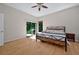 Open main bedroom with ensuite bathroom, wood floors, ceiling fan, and sliding glass door at 602 Nighthawk Cir, Winter Springs, FL 32708