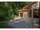 Private patio area with tile and natural vegetation provides outdoor living space at 602 Nighthawk Cir, Winter Springs, FL 32708