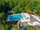 Large community pool surrounded by lush greenery and lounge chairs for residents at 602 Nighthawk Cir, Winter Springs, FL 32708