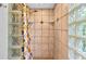 Shower with decorative tile and multiple shelves at 602 Nighthawk Cir, Winter Springs, FL 32708