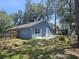 This back exterior features a cement patio and ample yard space at 6436 Fig Leaf St, Magnolia Square, FL 34771