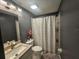 The bathroom features a modern vanity, toilet, and a shower with a colorful polka dot curtain at 6436 Fig Leaf St, Magnolia Square, FL 34771