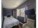 This small bedroom has modern gray walls and a vaulted ceiling for a cozy appeal at 6436 Fig Leaf St, Magnolia Square, FL 34771