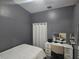 The bedroom features neutral wall-to-wall carpeting, a vanity with mirror, and a closet at 6436 Fig Leaf St, Magnolia Square, FL 34771