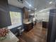 Modern kitchen featuring dark wood cabinets, white countertops, and stainless steel appliances at 6436 Fig Leaf St, Magnolia Square, FL 34771