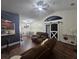 Spacious living room featuring vaulted ceilings, a sliding barn door, and a dining table adjacent to the kitchen at 6436 Fig Leaf St, Magnolia Square, FL 34771