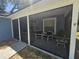 View of a screened patio with outdoor seating and access to the house at 6436 Fig Leaf St, Magnolia Square, FL 34771