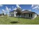 Two-story home with a spacious backyard and well-maintained lawn at 706 Junonia Blvd, New Smyrna Beach, FL 32168
