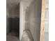 Unfinished bathroom shows concrete walls and doorway to another room at 706 Junonia Blvd, New Smyrna Beach, FL 32168