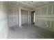 Unfinished bedroom reveals a closet, doorway and concrete flooring at 706 Junonia Blvd, New Smyrna Beach, FL 32168