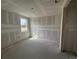 Unfinished bedroom features concrete flooring and a window overlooking a street at 706 Junonia Blvd, New Smyrna Beach, FL 32168