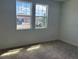 Bedroom with carpet floors, large window views and bright natural light at 706 Junonia Blvd, New Smyrna Beach, FL 32168