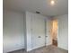 Bedroom featuring a double door closet and carpet flooring at 706 Junonia Blvd, New Smyrna Beach, FL 32168
