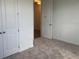 Carpeted bedroom with double door closet and standard interior door at 706 Junonia Blvd, New Smyrna Beach, FL 32168