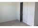 Standard bedroom with carpet flooring and door to the closet at 706 Junonia Blvd, New Smyrna Beach, FL 32168