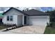 Charming single-story home with a brick driveway and well-maintained landscaping at 706 Junonia Blvd, New Smyrna Beach, FL 32168