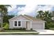 Charming single-story home featuring a light gray facade, well-manicured lawn and a two-car garage at 706 Junonia Blvd, New Smyrna Beach, FL 32168