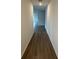 Hallway featuring sleek hardwood floors leading to a naturally lit living space at 706 Junonia Blvd, New Smyrna Beach, FL 32168